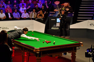 Jimmy White playing a shot at the table in the 2023 World Seniors Snooker Championship.