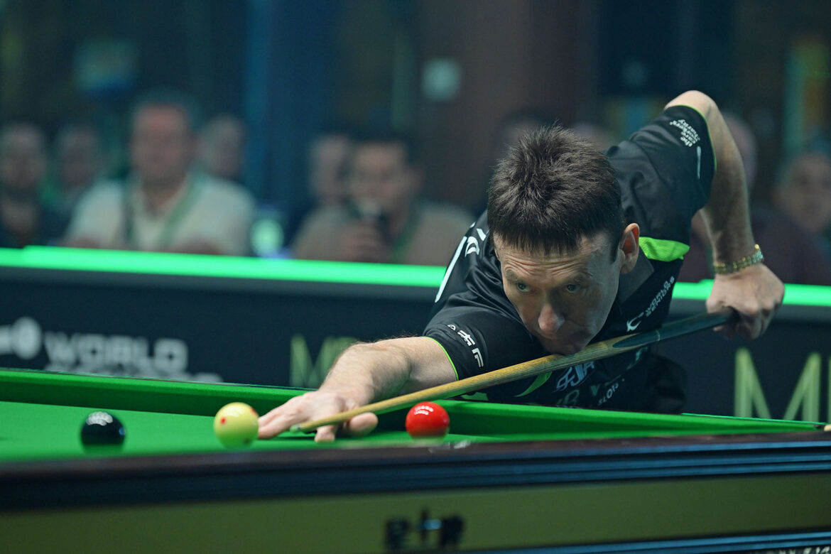 Jimmy White plays a shot.