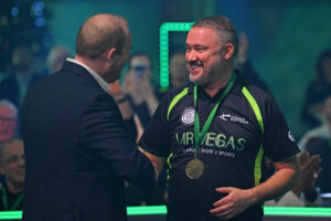 Stephen Hendry smiling with his winning medal around his neck being congratulated by Jason Francis.